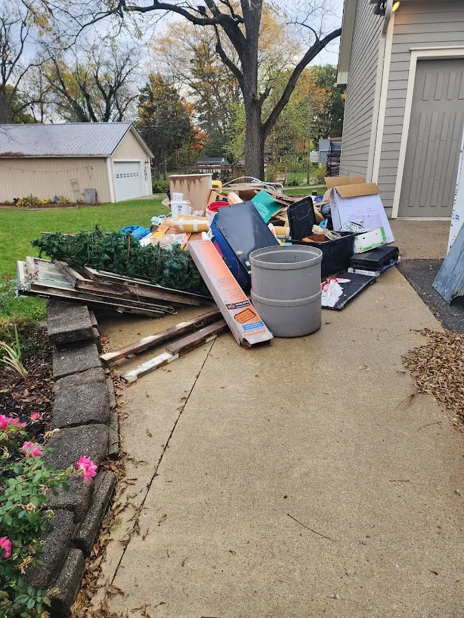 Dumpster being loaded with debris for Estate Cleanout Dumpster Rental in Esparto